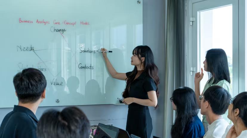 A TRG intern presenting at a whiteboard during an Exchange Session